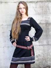 Woman wearing a short black alpaca dress with long sleeves and jacquard pattern, model Giuditta.